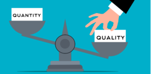 A balance scale with 'quantity' and 'quality' with a hand pushing the 'quality' side much lower.